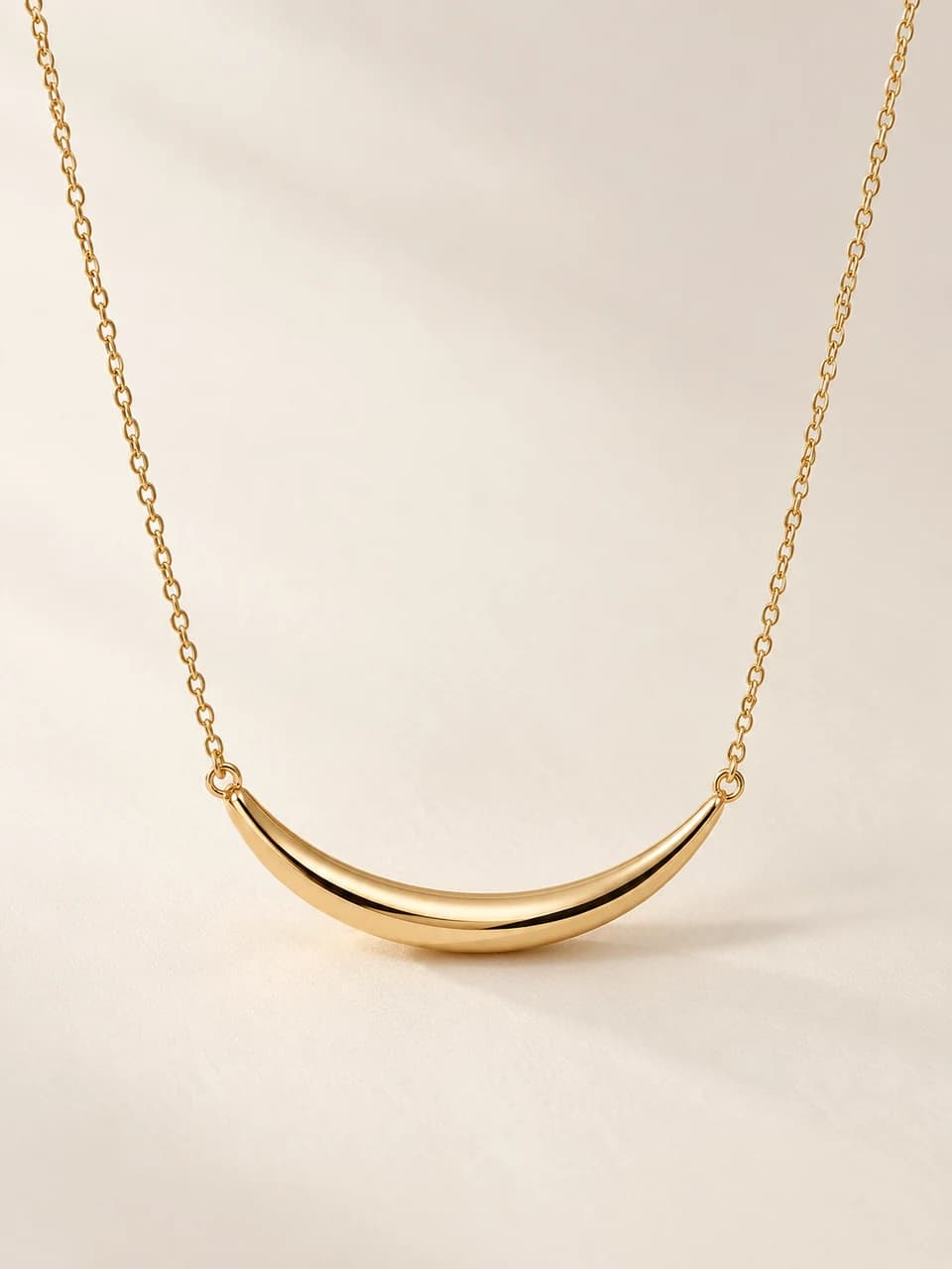 AI-generated Arc Pendant concept — Gold-tone. Unproduced; final specifications subject to change.