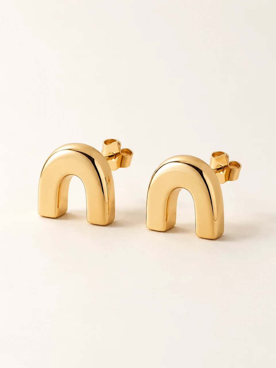 AI-generated Gate Studs concept — Gold-tone. Unproduced; final specifications subject to change.