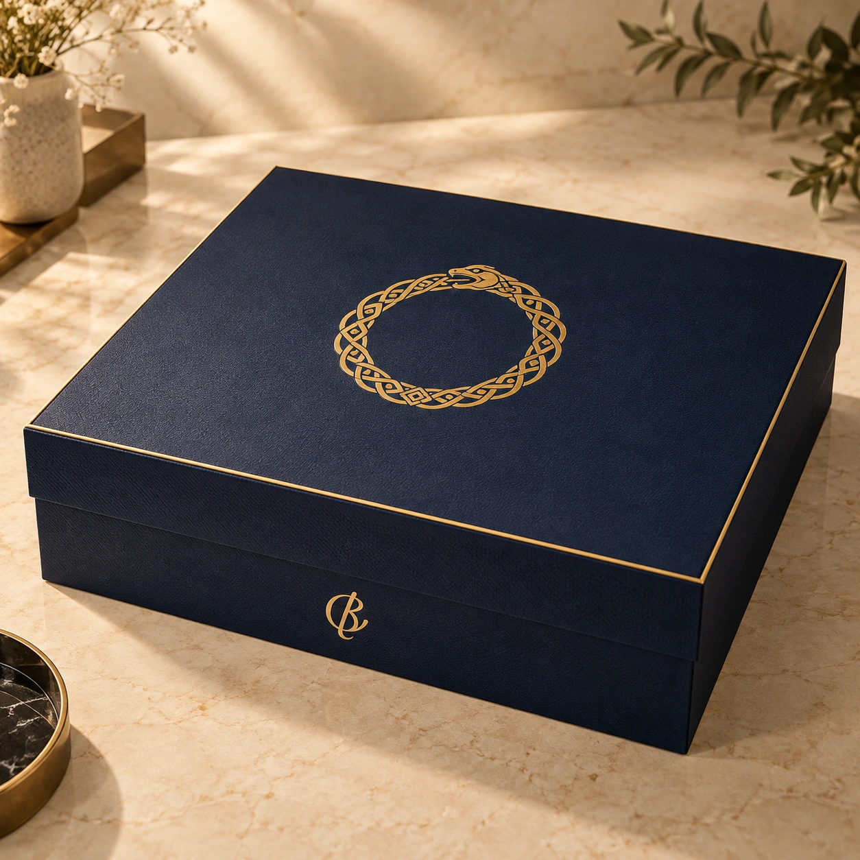 Closed navy Grand Box with gold Ouroboros emblem